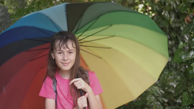 Happy girl with a rainbow umbrella.