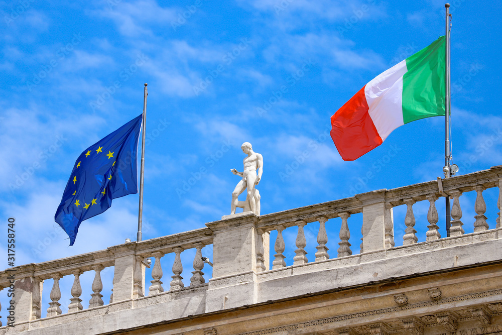 Wall mural Italian flag and European Union flag on a building in Rome.