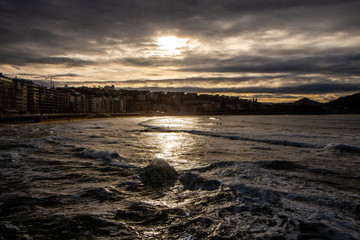 Coast or La Concha beach of San Sebastian Donostia in Spain in sunset during vacation time in summer with cloudy sky