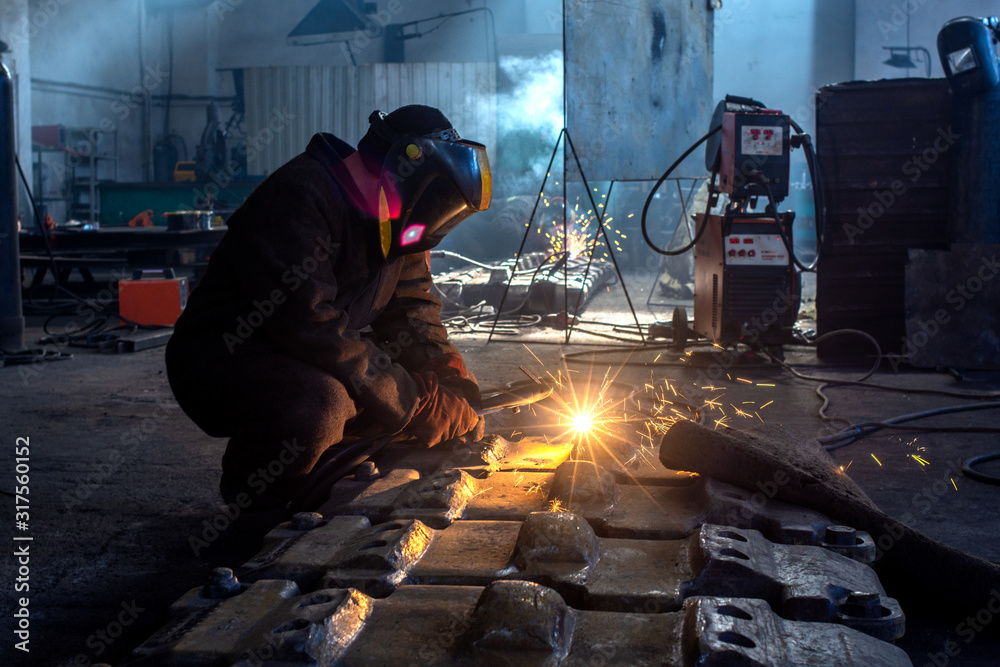 Wall mural welder works at the factory as a welding machine