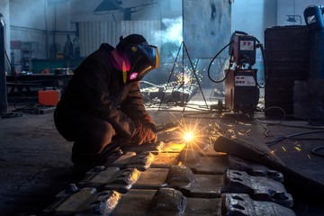 welder works at the factory as a welding machine