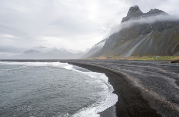 Hvalnes beach and Eystrahorn mountains on the south coast of Iceland during foggy weather. Travel and explorer concept.