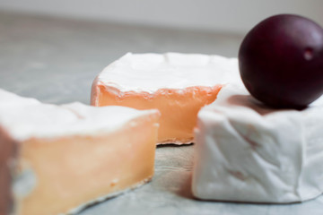 Camembert cheese on a table with vegetables