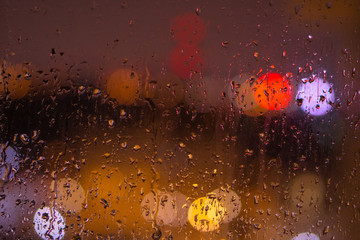 water drops on glass with red-orange backlight
