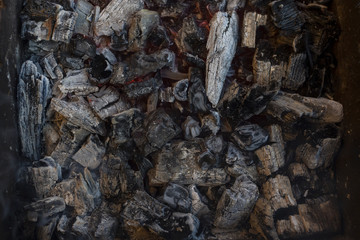 Burning firewood in a rusty barbecue