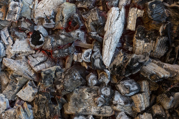 Burning firewood in a rusty barbecue