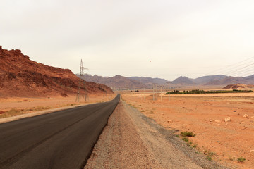 Street to desert Wadi Rum and mountain panorama, Jordan
