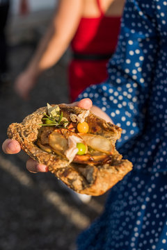 Women holding a Buckwheat Pear Galette with ground cherries and rosemary