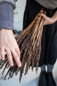 Flower farmer preparing bundles of dried flowers