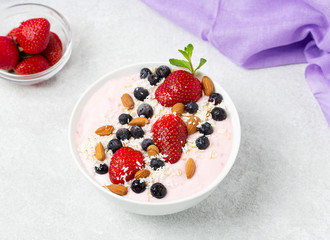 Healthy Breakfast berry cocktail bowl with strawberries, blueberries and almonds.