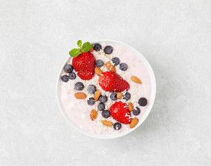 Healthy Breakfast berry cocktail bowl with strawberries, blueberries and almonds.