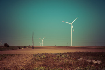  empty fields and wind turbines over clear blue sky