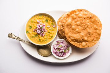 Dal pakwan is an authentic Sindhi breakfast. It is a combination of deepfried, crisp and unpuffed Maida puris served with Daal made using chana or split chickpea. selective focus