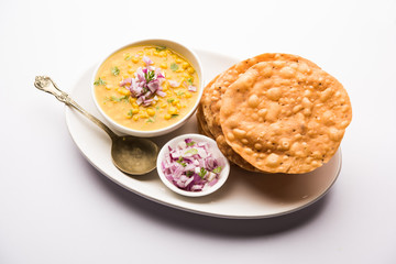 Dal pakwan is an authentic Sindhi breakfast. It is a combination of deepfried, crisp and unpuffed Maida puris served with Daal made using chana or split chickpea. selective focus