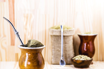 Chimarrão, or mate, is a characteristic drink of the culture of southern South America. mate bowl with mate herb, pump and accessories for preparing mate herb. Space for text.