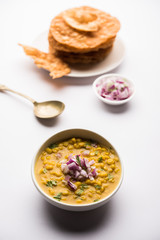 Dal pakwan is an authentic Sindhi breakfast. It is a combination of deepfried, crisp and unpuffed Maida puris served with Daal made using chana or split chickpea. selective focus