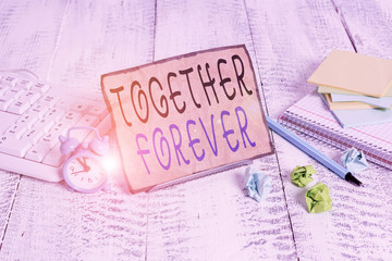 Writing note showing Together Forever. Business concept for showing who promise to love one another...