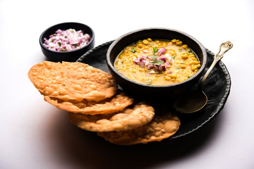 Dal pakwan is an authentic Sindhi breakfast. It is a combination of deepfried, crisp and unpuffed Maida puris served with Daal made using chana or split chickpea. selective focus