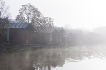 Fototapeta na wymiar Foggy view of Porvoo city and Porvoonjoki river in early morning, old wooden houses, Porvoo, Finland