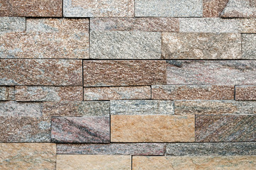 Grunge brown ,beige,orange,grey stone wall tiles texture backdrop.Wall natural brown stone dirty,dust.Wall and panel marble natural pattern for architecture and interior design or abstract background.