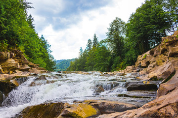 Scenic landscape with a steep mountain river_