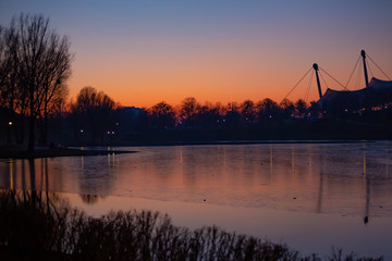 On January 1st 2020, in the first sunset of the year, the Olympia Park in Munich, Germany, presents...