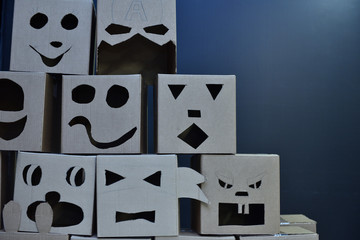 Funny square heads of robots with emotions from a cardboard box