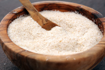 Portion of Psyllium Seeds on rustic dark background. Psyllium seed husks on wood