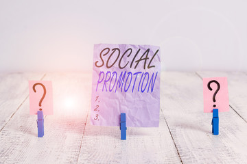 Text sign showing Social Promotion. Business photo showcasing advancing students to the next grade to be with their peers Scribbled and crumbling sheet with paper clips placed on the wooden table