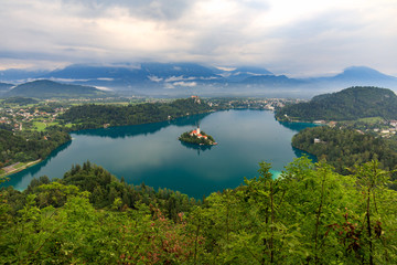 Fototapeta na wymiar View at the lake Bled from Mala Osojnica mountain in Slovenia during the overcast foggy day