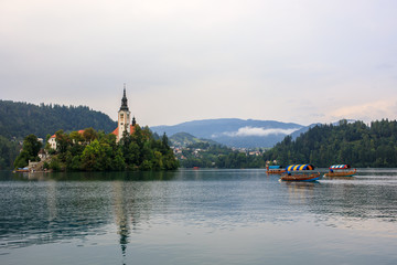 Fototapeta na wymiar Tourists in Pletna boat at lake Bled, Slovenia