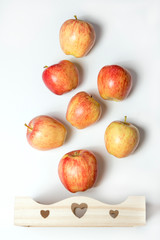 Wooden box full of fresh apples isolated on a white background