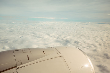 view of the wing of an airplane during the flight with a very cloudy day