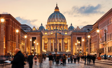 Vatican City Holy( See). Rome, Italy. Dome of St. Peters Basil cathedral at Saint Peters Square. Evening sunset, golden hour with evening sky and street lamps.