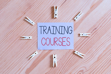 Handwriting text Training Courses. Conceptual photo lessons to teach the skills and knowledge for a job Colored clothespin papers empty reminder wooden floor background office