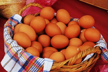 Fresh brown eggs in a wicker basket