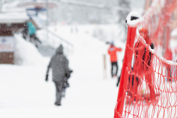 Red net fencing on a sky resort abstract background.