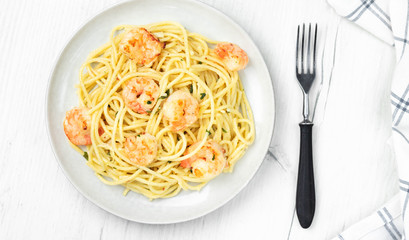 Pasta spaghetti with prawns on light background. Top view