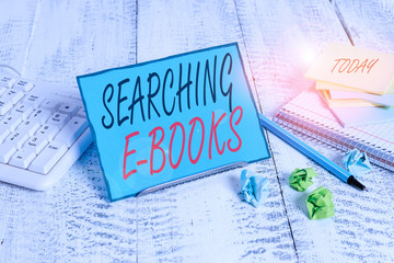 Handwriting text Searching E Books. Conceptual photo looking for an electronic form of educational material Notepaper stand on buffer wire in between computer keyboard and math sheets