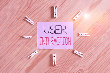 Handwriting text User Interaction. Conceptual photo the conduit between huanalysis and computer interaction Colored clothespin papers empty reminder wooden floor background office
