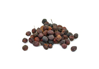 Dried medicinal herbs raw materials isolated on white. Fruit of Crataegus commonly called hawthorn, thornapple, May-tree, whitethorn, or hawberry. Cure for the heart.