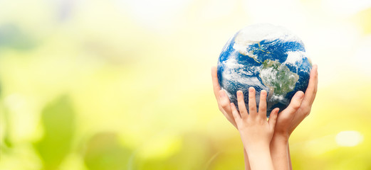Earth globe in family hands. World environment day. Elements of this image furnished by NASA.