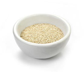 Organic Quinoa (Chenopodium quinoa) seeds in a white bowl isolated on white background. Macro close up. Top view. quinoa seeds isolated on white background. 