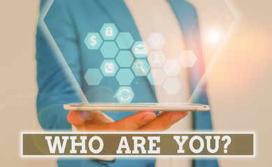 Writing note showing Who Are You question. Business concept for Identify yourself description...
