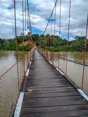 Suspension bridge that crossing Mentarang River, Malinau, outback of Borneo, Indonesia