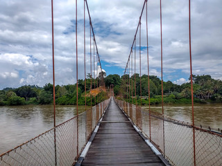 Suspension bridge that crossing Mentarang River, Malinau, outback of Borneo, Indonesia