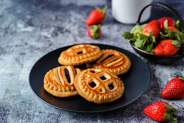 Cookies with strawberry filling in the plate. Spanish pastry