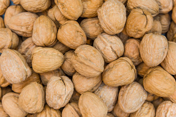 Walnut in a peel the background. Close up shot of whole walnut isolated on white background. Group of walnut whole on a white background.