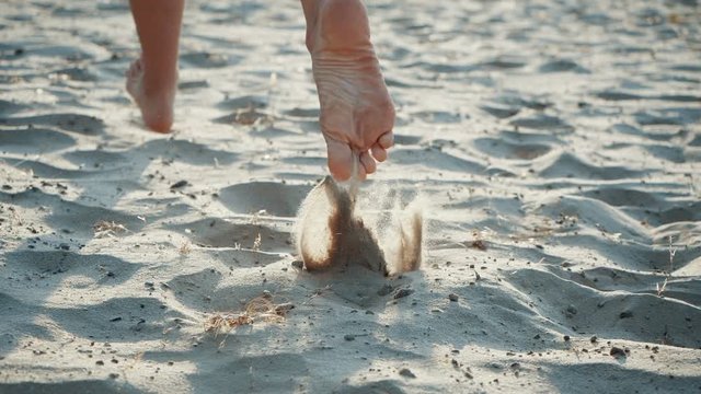 Feet running in the sand. Jogging man closeup barefoot runner legs and feet on the beach. Sporty legs exercising on a runner beach working out on a sunny day. Low section close-up in slow motion.