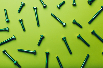 Naklejka premium Bolts closeup on green background.